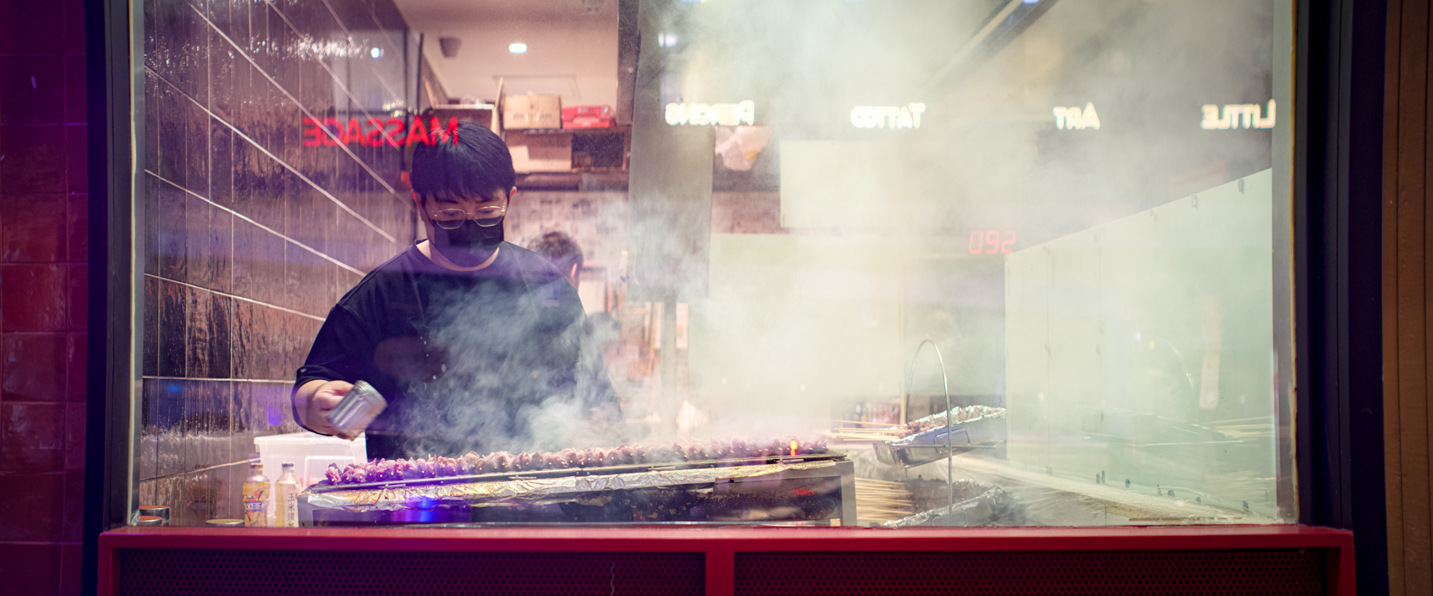 Anamorphic photo of a cook in a window.